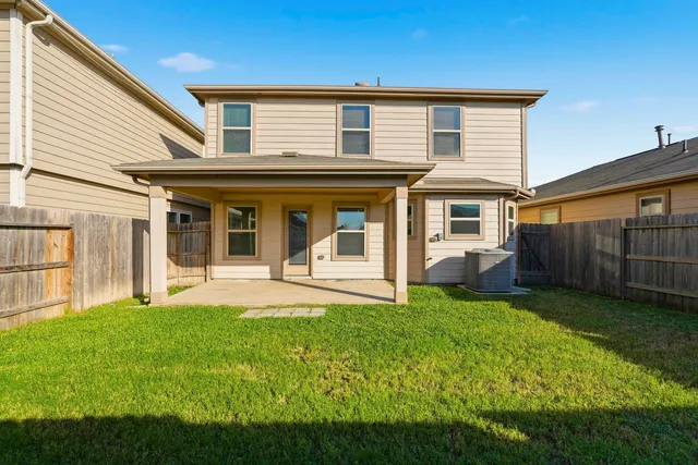 a view of a house with a yard and sitting area