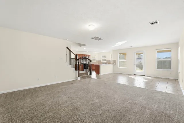 a view of a livingroom with furniture and an empty room