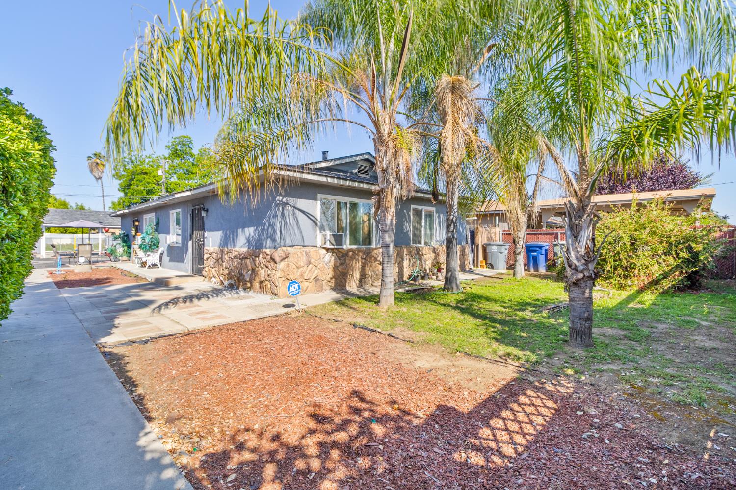 715 Faller Avenue Sanger, CA 93657 - Photo 1 of 40 a row of palm trees in front of a house