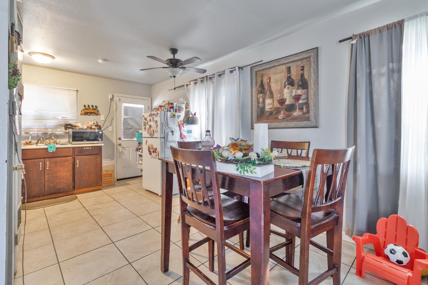 715 Faller Avenue Sanger, CA 93657 - Photo 23 of 40 a dining room filled a chandelier and kitchen view