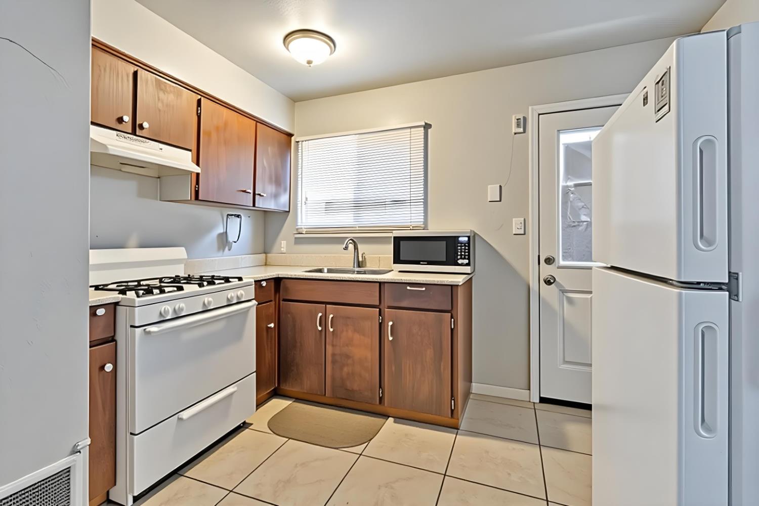 715 Faller Avenue Sanger, CA 93657 - Photo 27 of 40 a kitchen with stainless steel appliances a refrigerator sink and cabinets