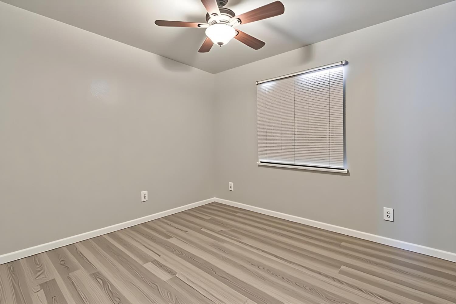 715 Faller Avenue Sanger, CA 93657 - Photo 35 of 40 a view of a room with wooden floor and a ceiling fan