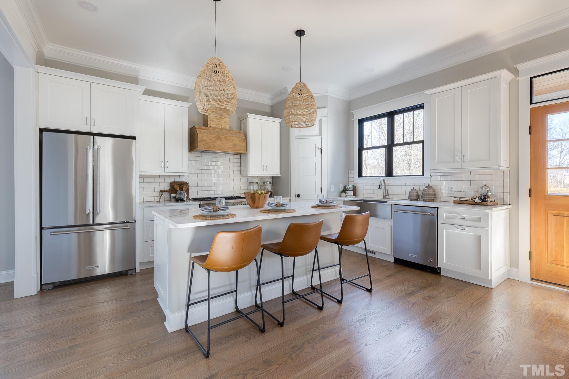 1010 Onslow Street Durham, NC 27705 - Photo 12 of 30 a kitchen with stainless steel appliances granite countertop a refrigerator a sink dishwasher a dining table and chairs with wooden floor