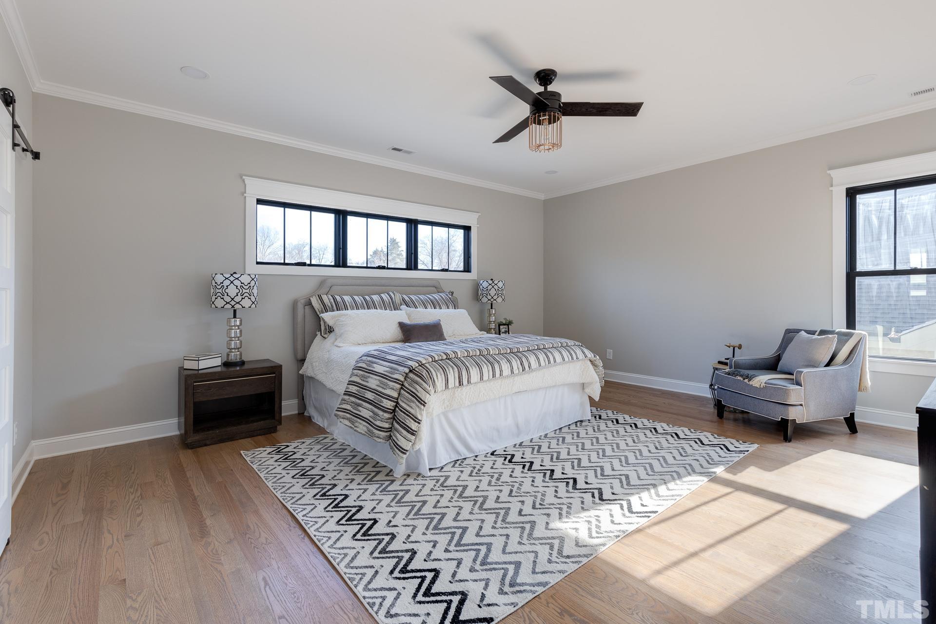 1010 Onslow Street Durham, NC 27705 - Photo 18 of 30 a bedroom with a bed and wooden floor