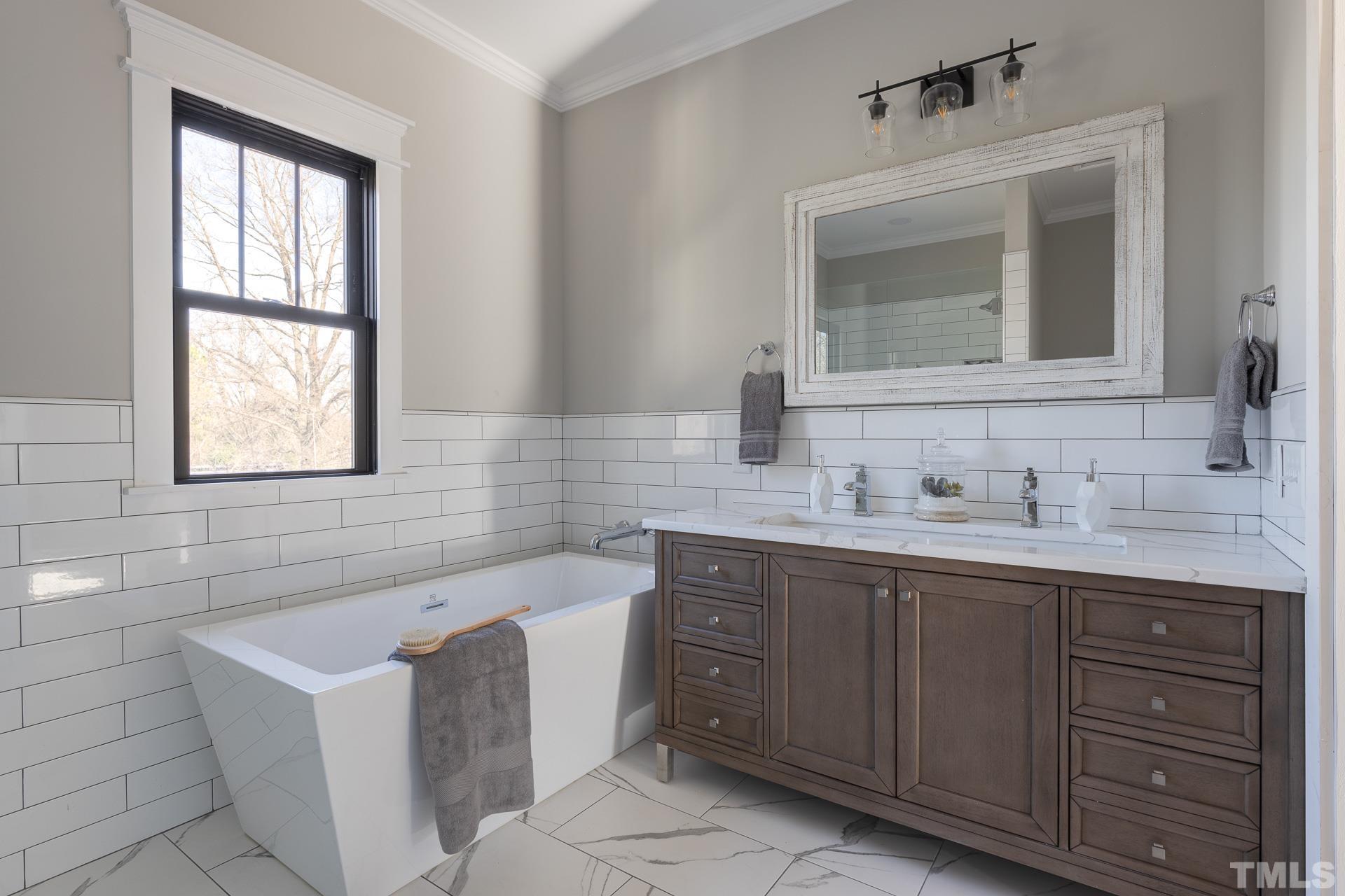 1010 Onslow Street Durham, NC 27705 - Photo 21 of 30 a bathroom with a tub sink and mirror