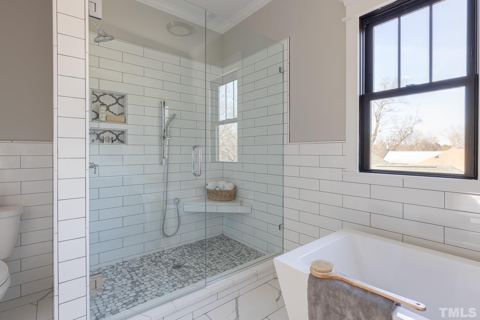 1010 Onslow Street Durham, NC 27705 - Photo 22 of 30 a bathroom with a granite countertop bathtub a window and a shower