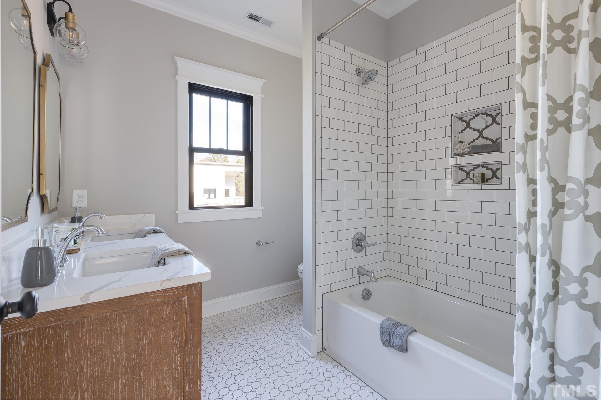 1010 Onslow Street Durham, NC 27705 - Photo 26 of 30 a bathroom with a tub sink and a shower