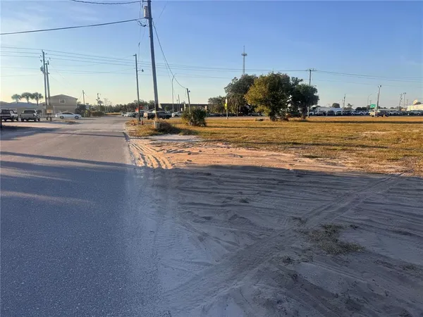 a view of a field with trees in the background