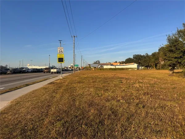 a view of an ocean with boats and palm trees