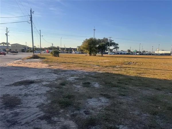 a view of dirt field with trees