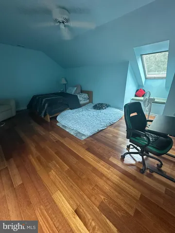 a room with gym equipment and wooden floor