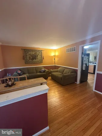 a view of a kitchen with stove and wooden floor
