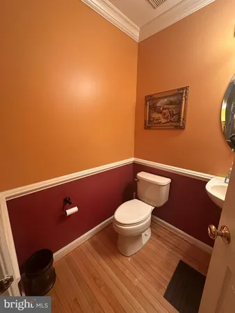 a bathroom with a toilet and a mirror
