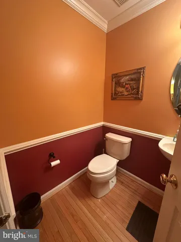 a bathroom with a toilet and a mirror