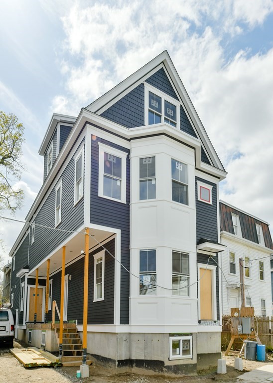 12 Ennis Road, Unit REAR Boston, MA 02119 - Photo 1 of 26 a front view of a house with balcony