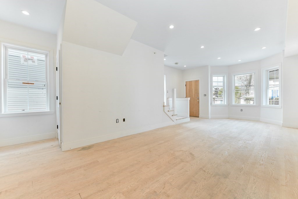 12 Ennis Road, Unit REAR Boston, MA 02119 - Photo 4 of 26 an empty room with a empty space and windows
