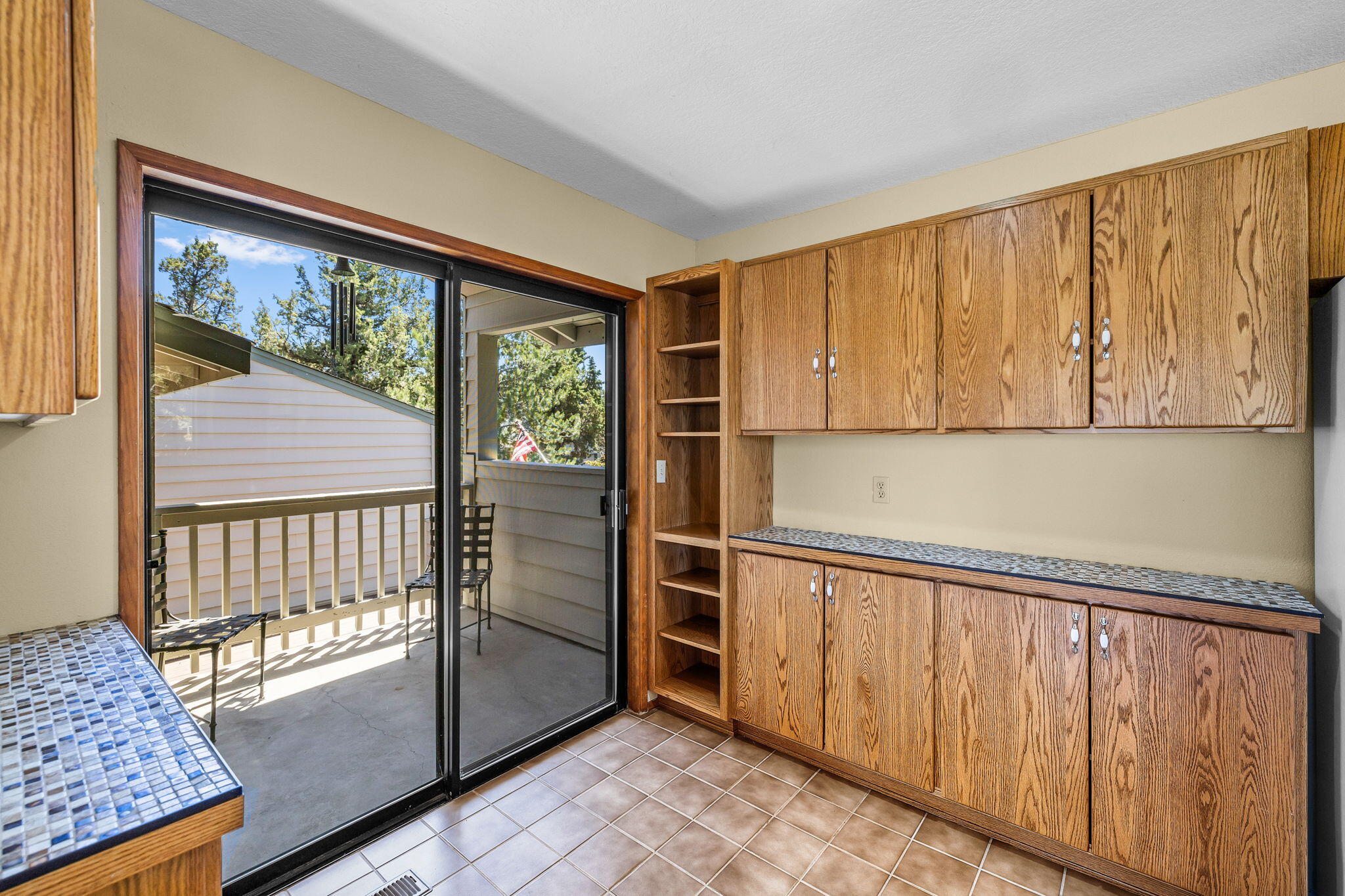 64586 McGrath Road Bend, OR 97701 - Photo 9 of 27 a view of a kitchen with wooden floor and iron stairs