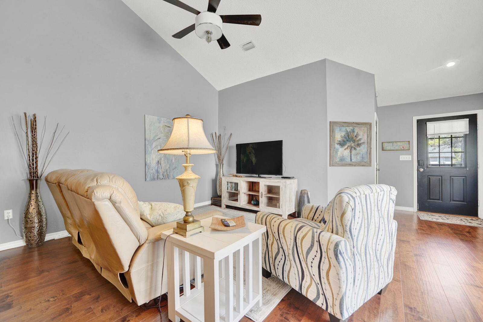 231 Vía Largo, Unit 39B Santa Rosa Beach, FL 32459 - Photo 3 of 50 a living room with furniture a flat screen tv and wooden floor