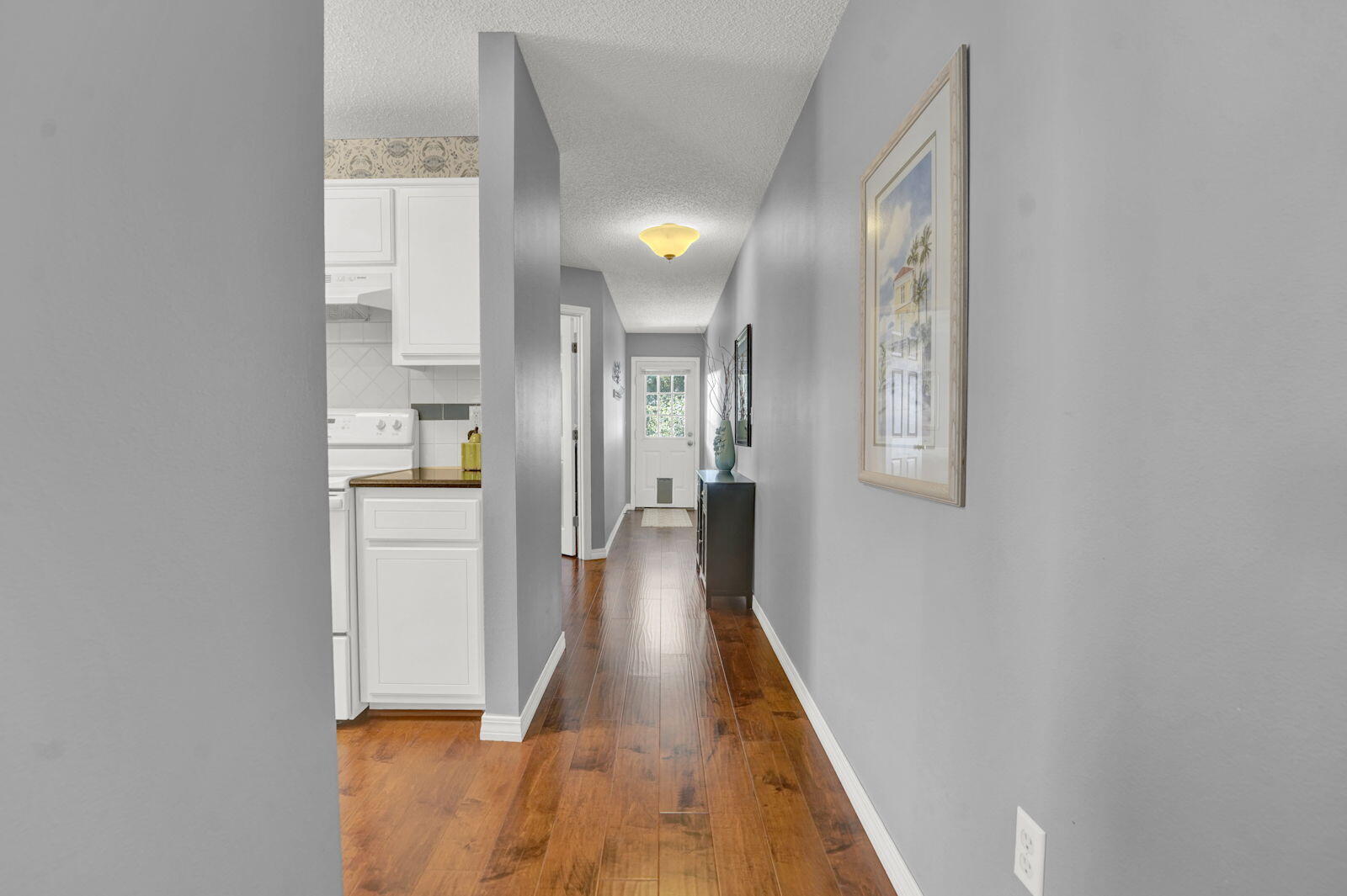 231 Vía Largo, Unit 39B Santa Rosa Beach, FL 32459 - Photo 6 of 50 a view of a hallway with wooden floor