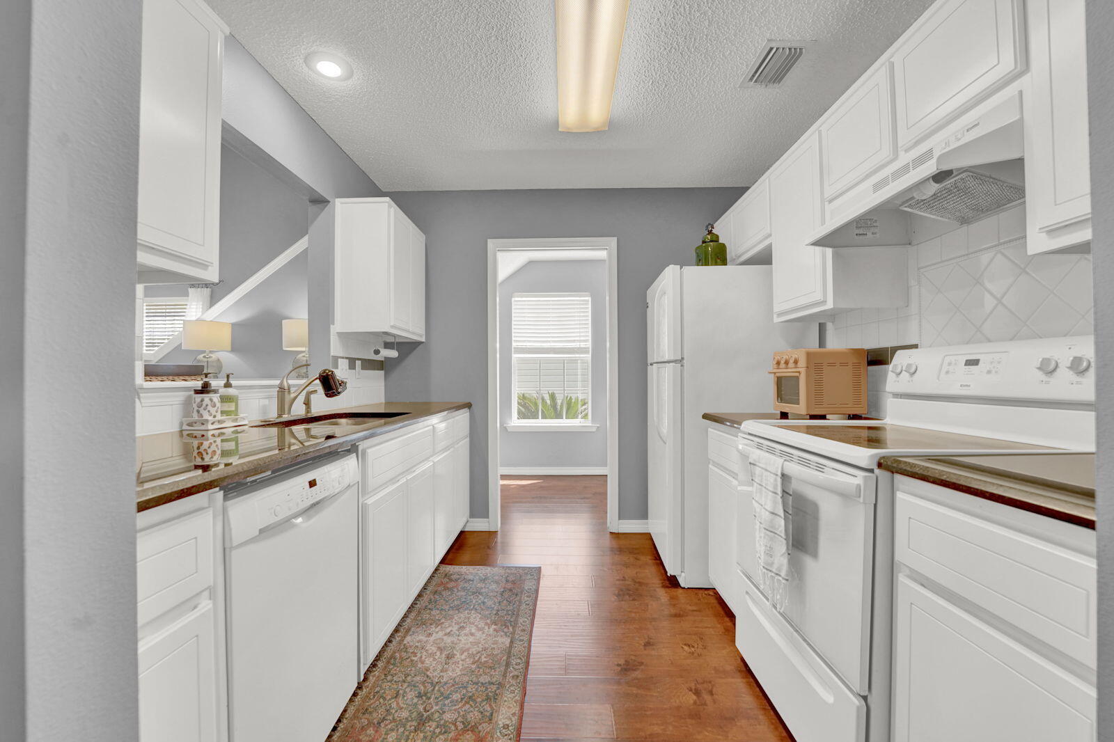 231 Vía Largo, Unit 39B Santa Rosa Beach, FL 32459 - Photo 7 of 50 a kitchen with a sink and refrigerator