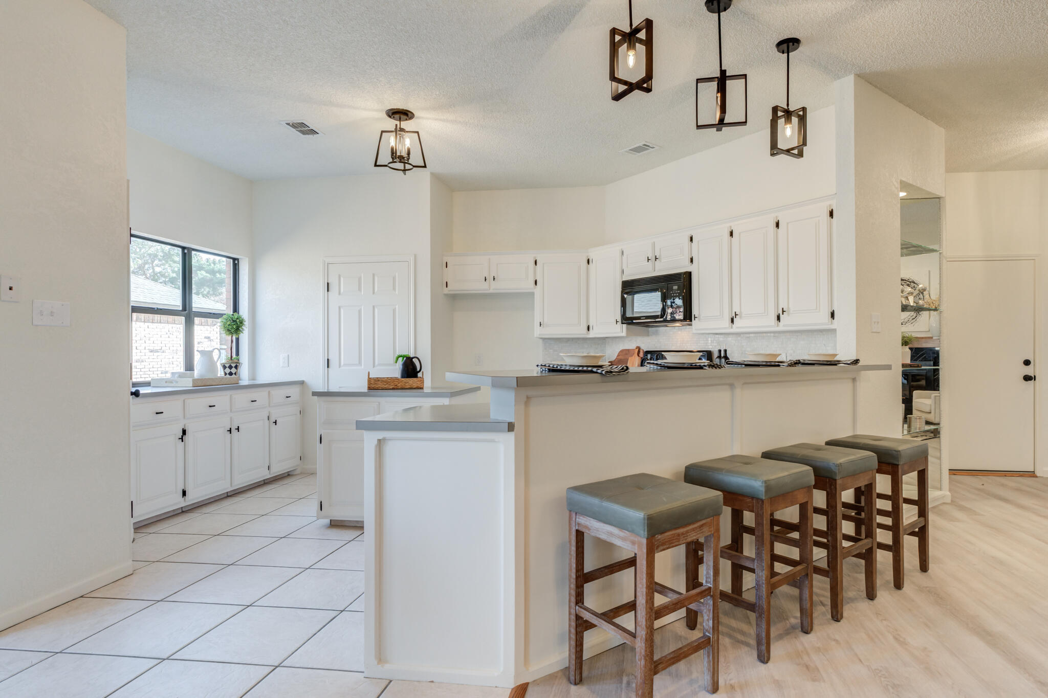 3602 101st Street Lubbock, TX 79423 - Photo 14 of 51 a kitchen with white cabinets and sink