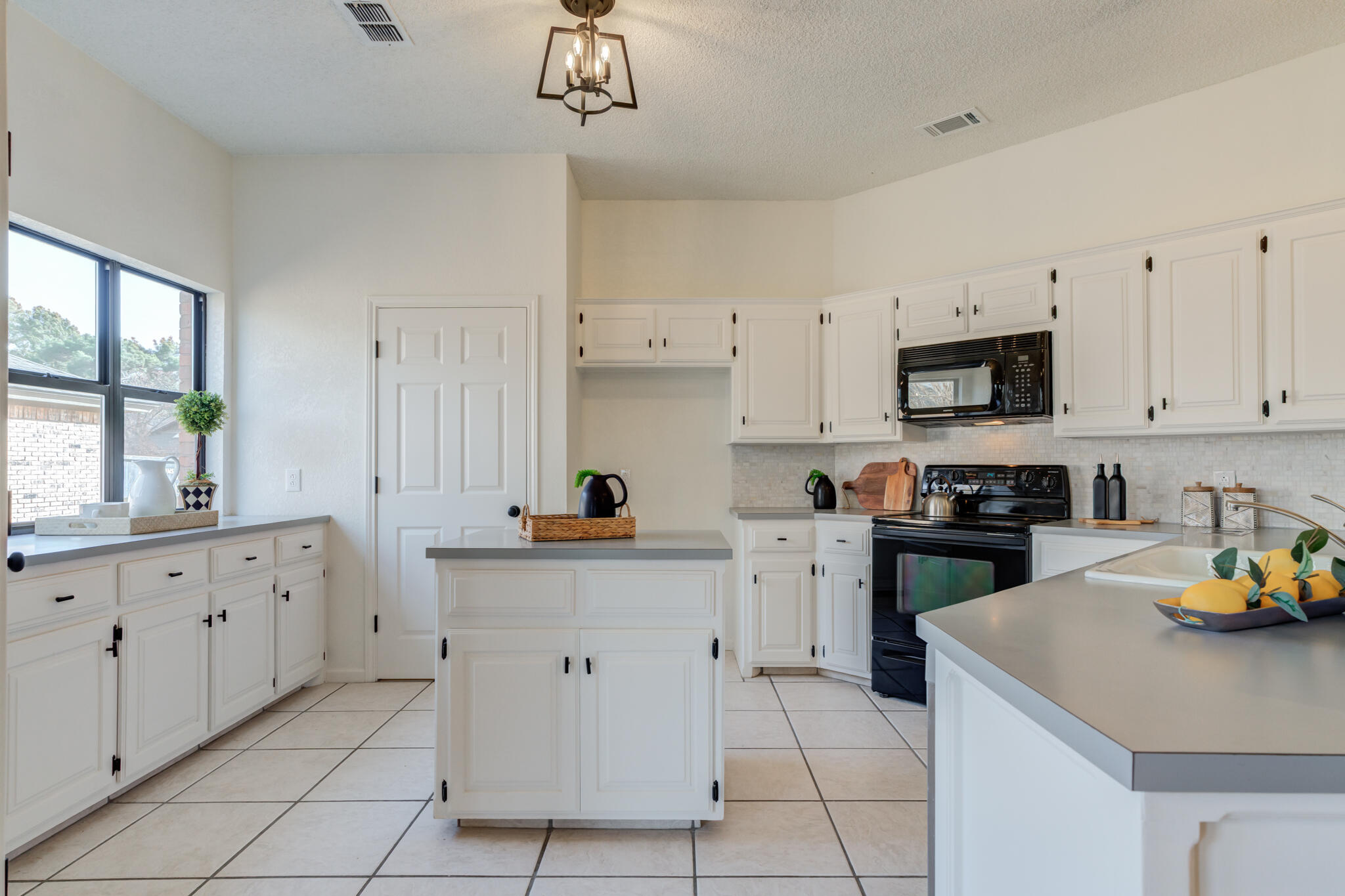 3602 101st Street Lubbock, TX 79423 - Photo 19 of 51 a kitchen with cabinets and window