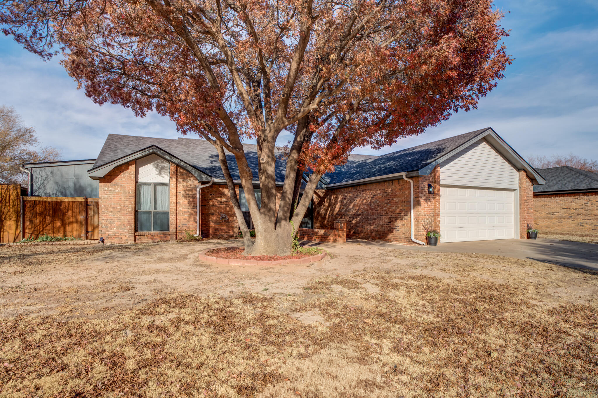 3602 101st Street Lubbock, TX 79423 - Photo 2 of 51 a front view of a house with a yard and garage
