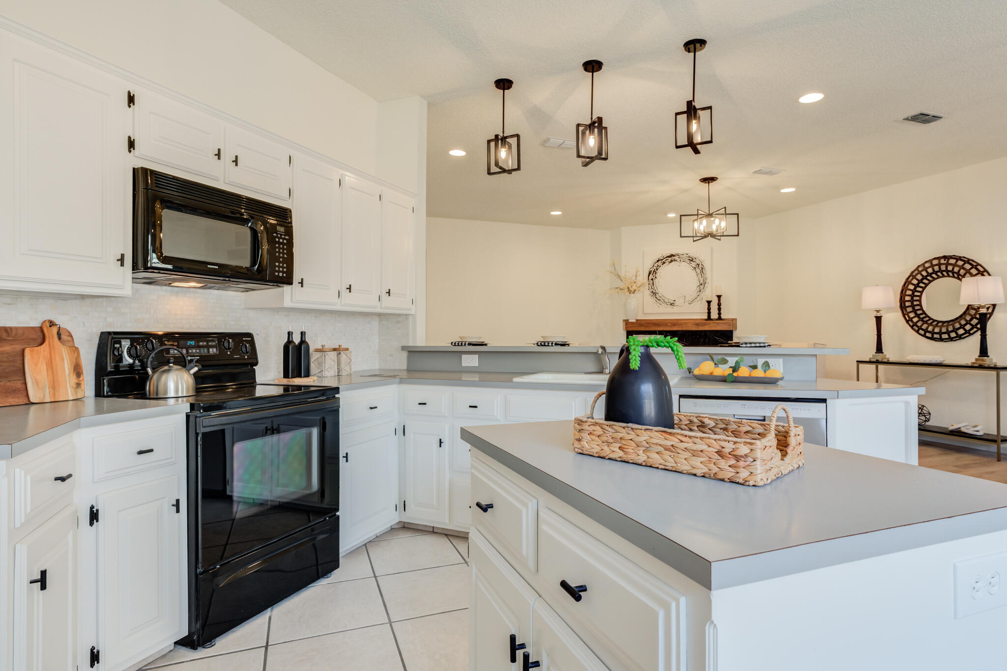 3602 101st Street Lubbock, TX 79423 - Photo 21 of 51 a kitchen with kitchen island granite countertop stainless steel appliances a sink a stove and cabinets