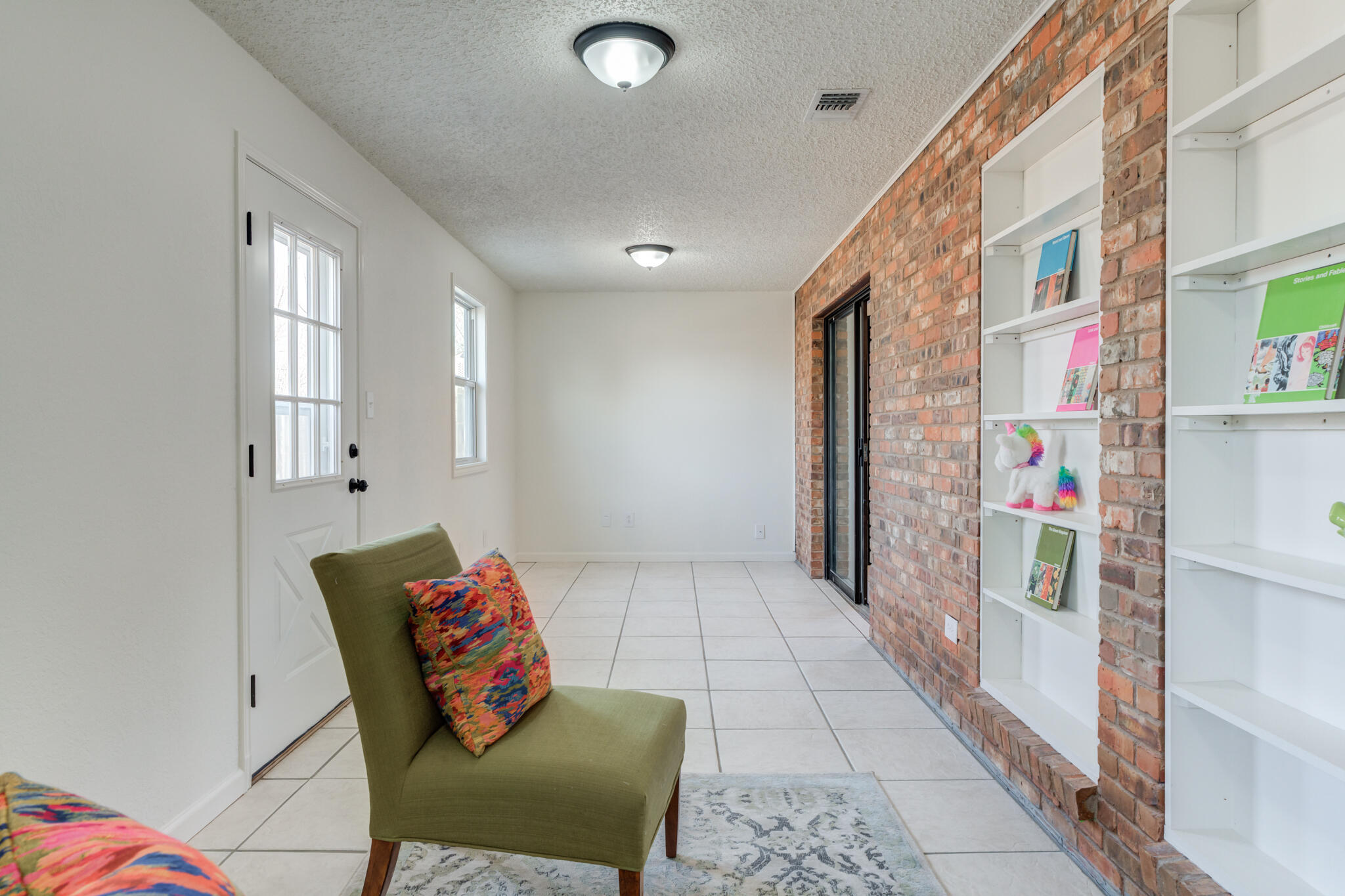 3602 101st Street Lubbock, TX 79423 - Photo 26 of 51 a living room with furniture and a book shelf