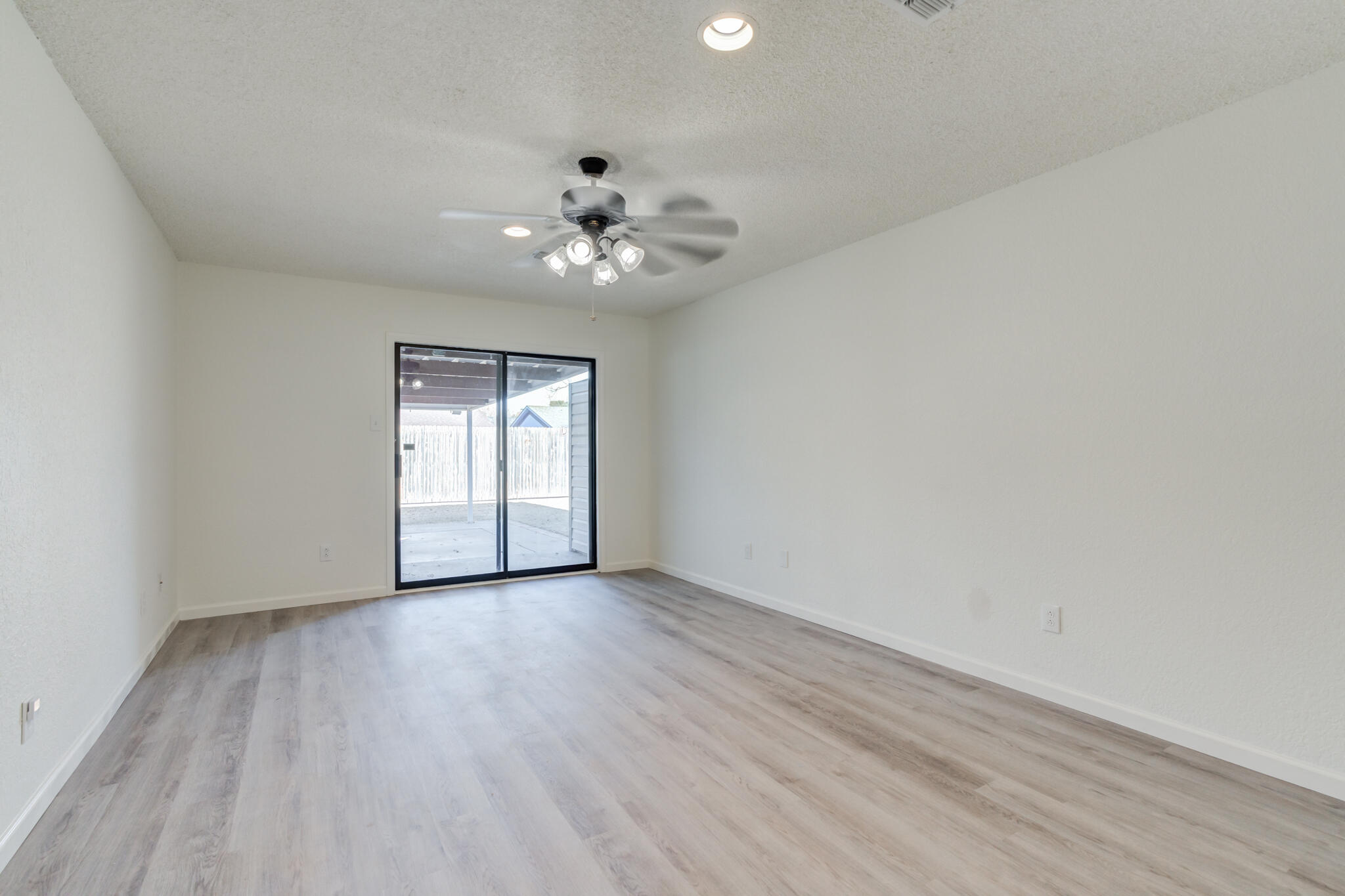 3602 101st Street Lubbock, TX 79423 - Photo 28 of 51 wooden floor in an empty room with a window