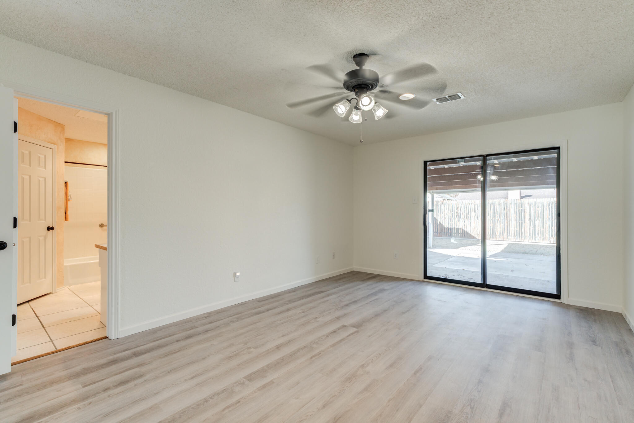 3602 101st Street Lubbock, TX 79423 - Photo 29 of 51 a view of an empty room with wooden floor and a window