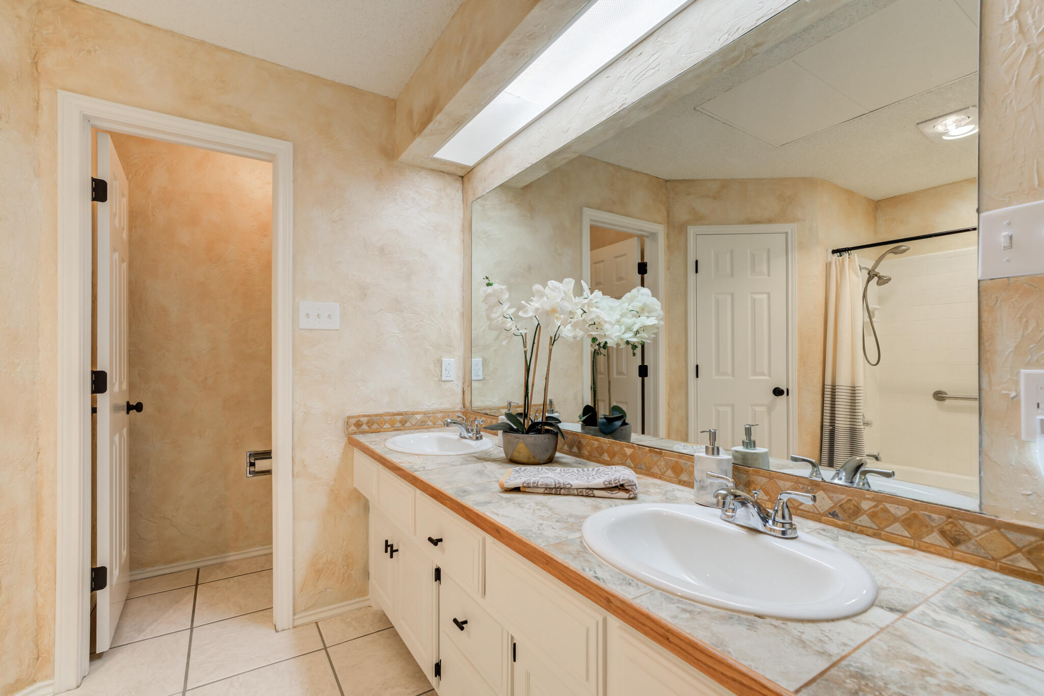 3602 101st Street Lubbock, TX 79423 - Photo 30 of 51 a bathroom with a granite countertop sink and a mirror