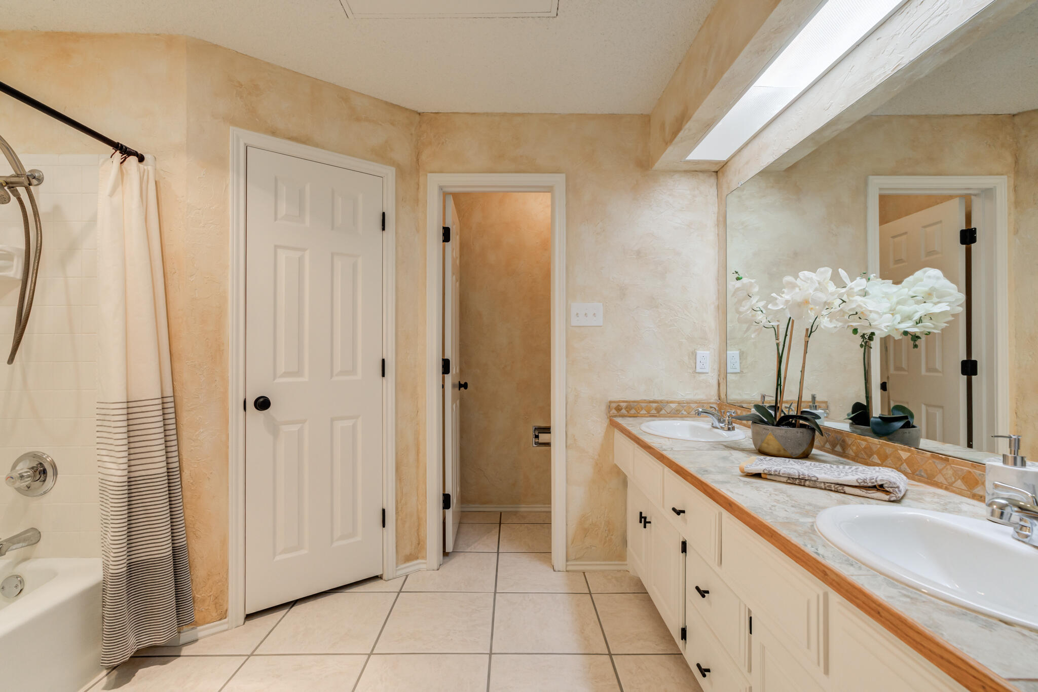 3602 101st Street Lubbock, TX 79423 - Photo 31 of 51 a spacious bathroom with a double vanity sink a mirror and a shower