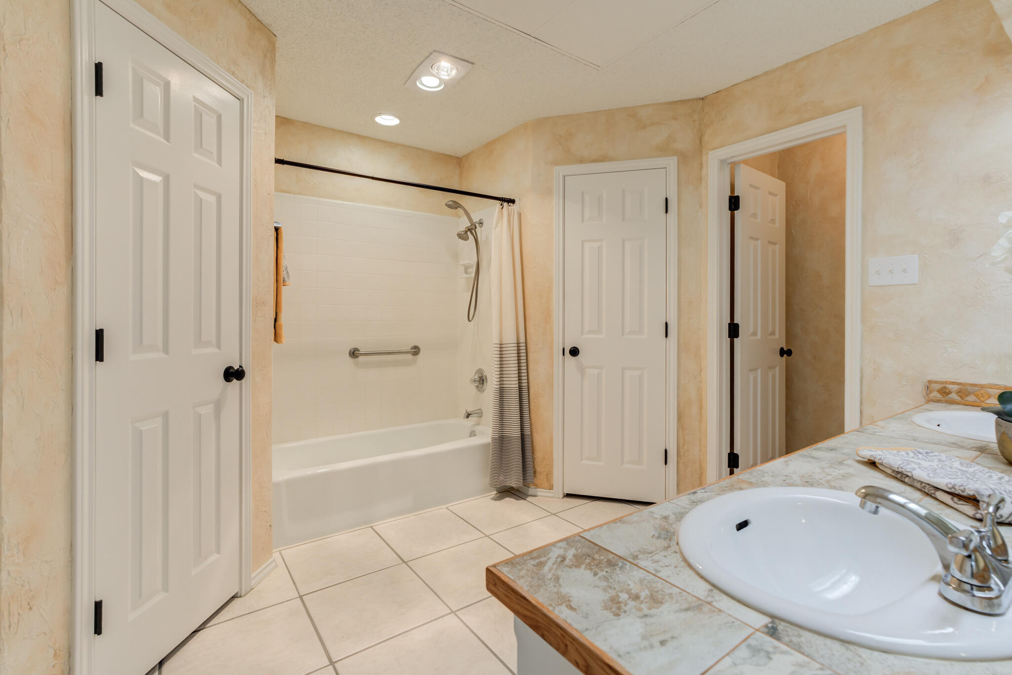 3602 101st Street Lubbock, TX 79423 - Photo 33 of 51 a bathroom with a bathtub and a shower