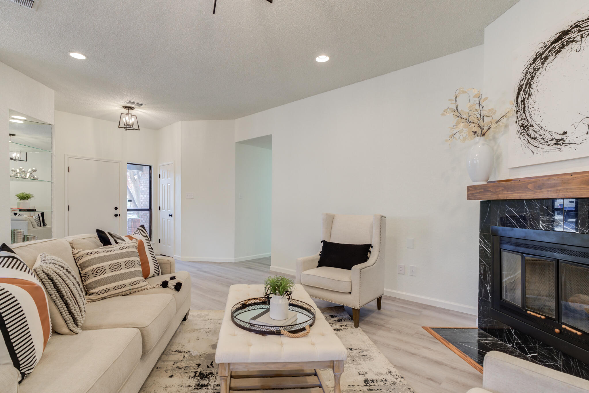 3602 101st Street Lubbock, TX 79423 - Photo 8 of 51 a living room with furniture a fireplace and a flat screen tv