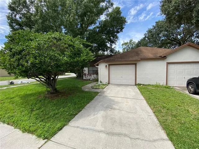 a front view of a house with a yard and a garage