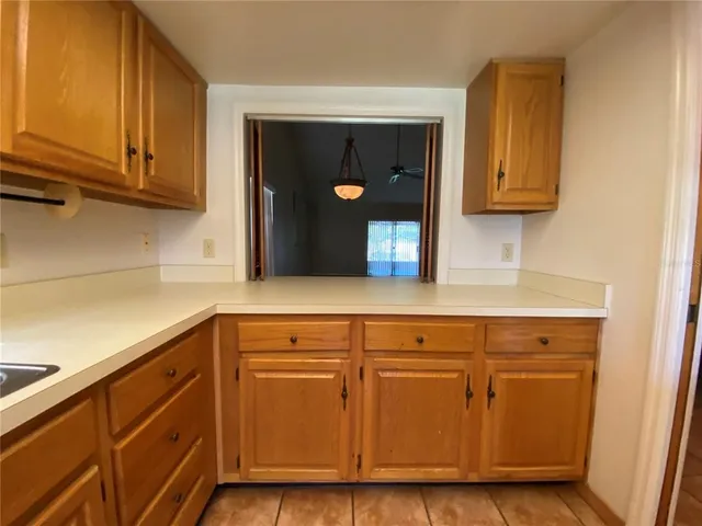 a kitchen with granite countertop cabinets and wooden floor