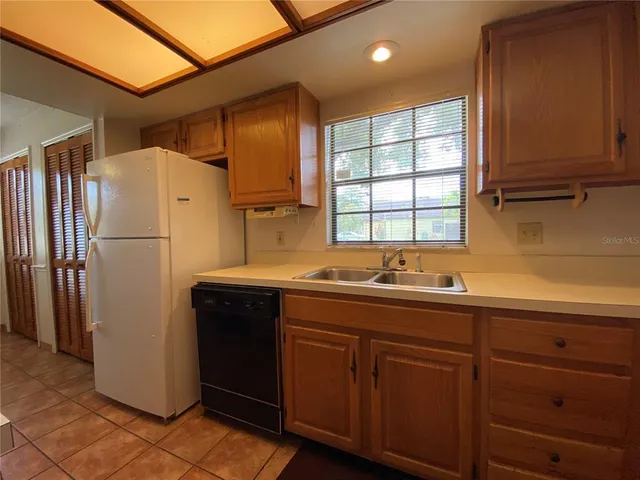 a kitchen with a refrigerator and a sink