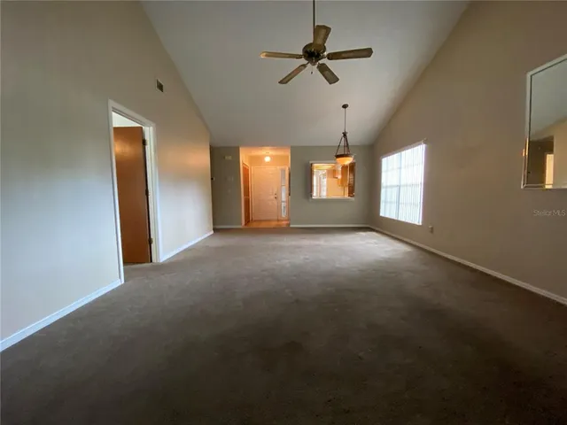 a view of a livingroom with a ceiling fan and window