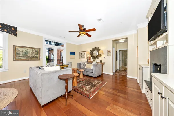 a living room with furniture flat screen tv and a view of kitchen