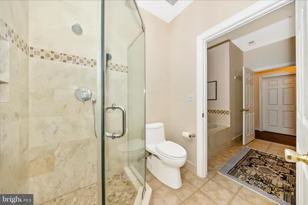 a spacious bathroom with a granite countertop sink a mirror and a shower