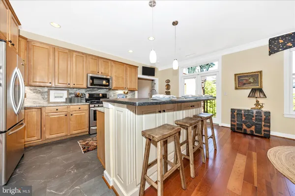 a kitchen with stainless steel appliances granite countertop a stove and a refrigerator