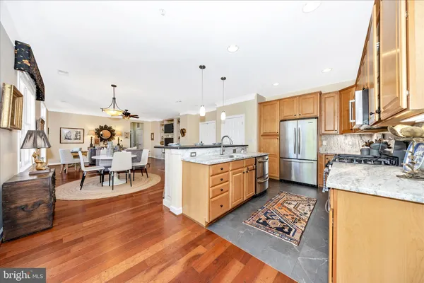 a kitchen with a table chairs refrigerator and cabinets