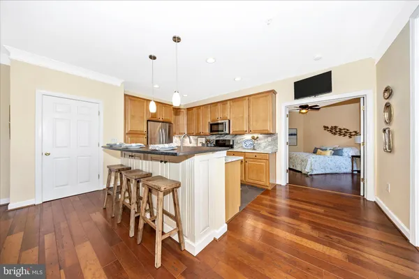 a kitchen with stainless steel appliances granite countertop a stove top oven a sink and white cabinets