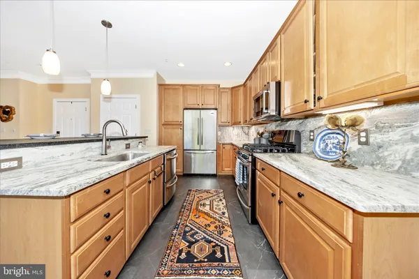 a kitchen with stainless steel appliances granite countertop a stove and a sink