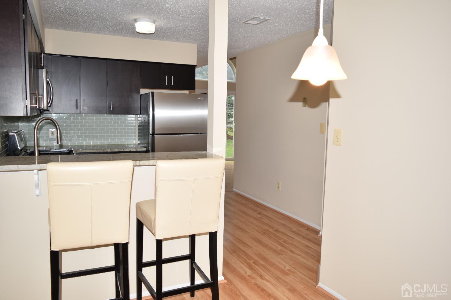 342 Lunar Road Piscataway, NJ 08854 - Photo 6 of 17 a kitchen with stainless steel appliances refrigerator and microwave