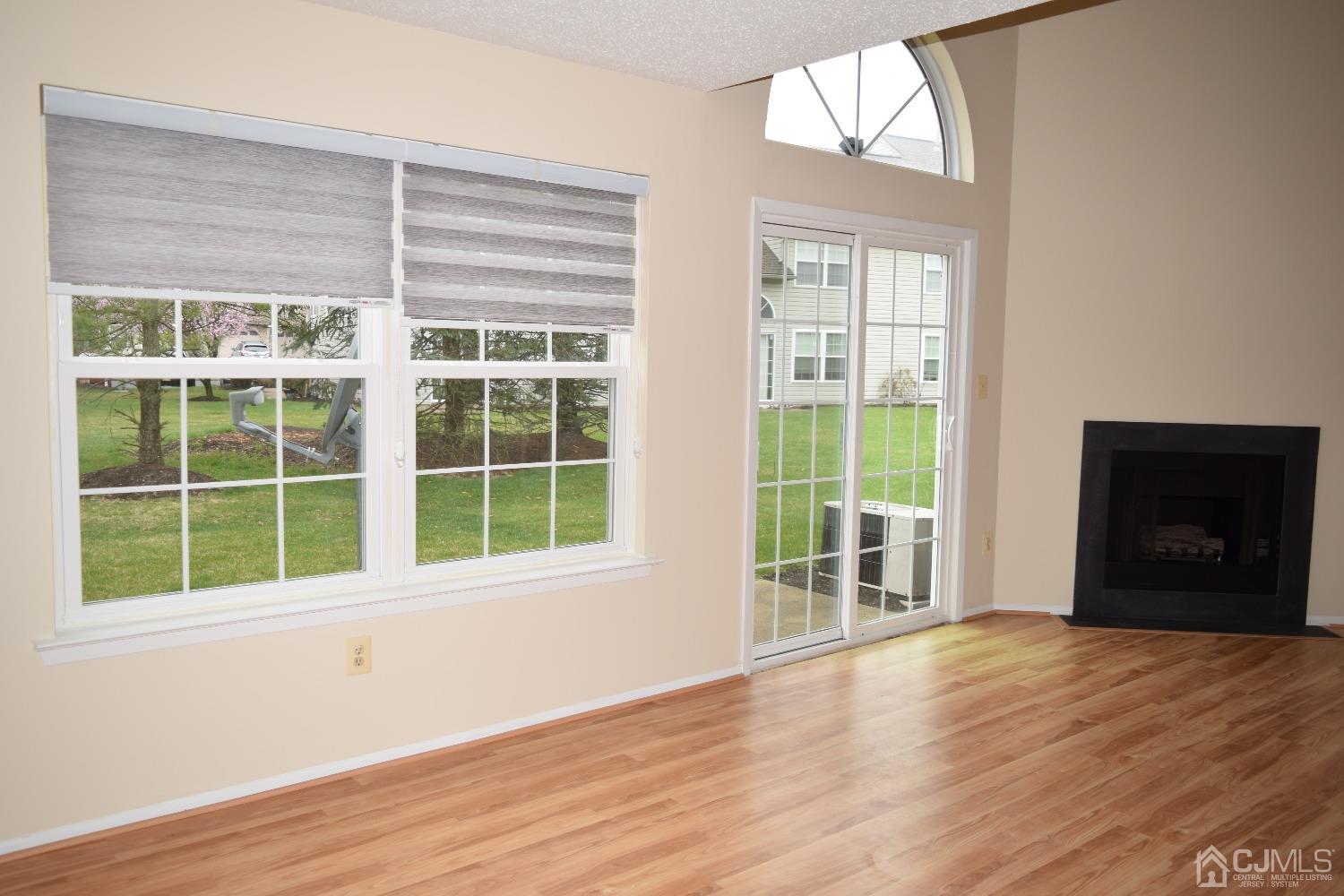 342 Lunar Road Piscataway, NJ 08854 - Photo 8 of 17 a view of an empty room with wooden floor and a window