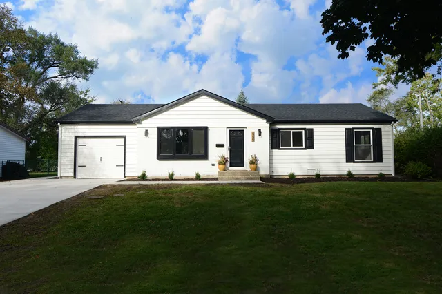 a front view of a house with a garden