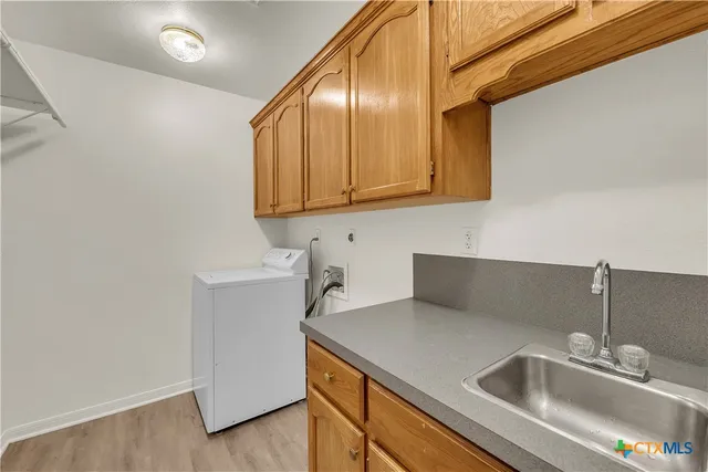 a kitchen with a sink cabinets and utility