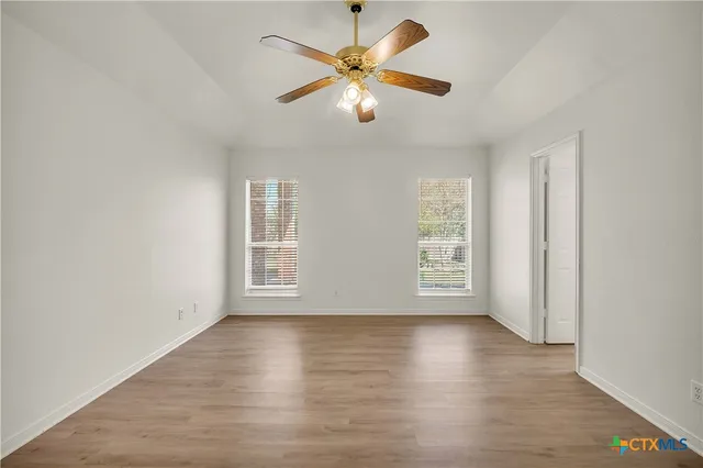 wooden floor in an empty room with a window